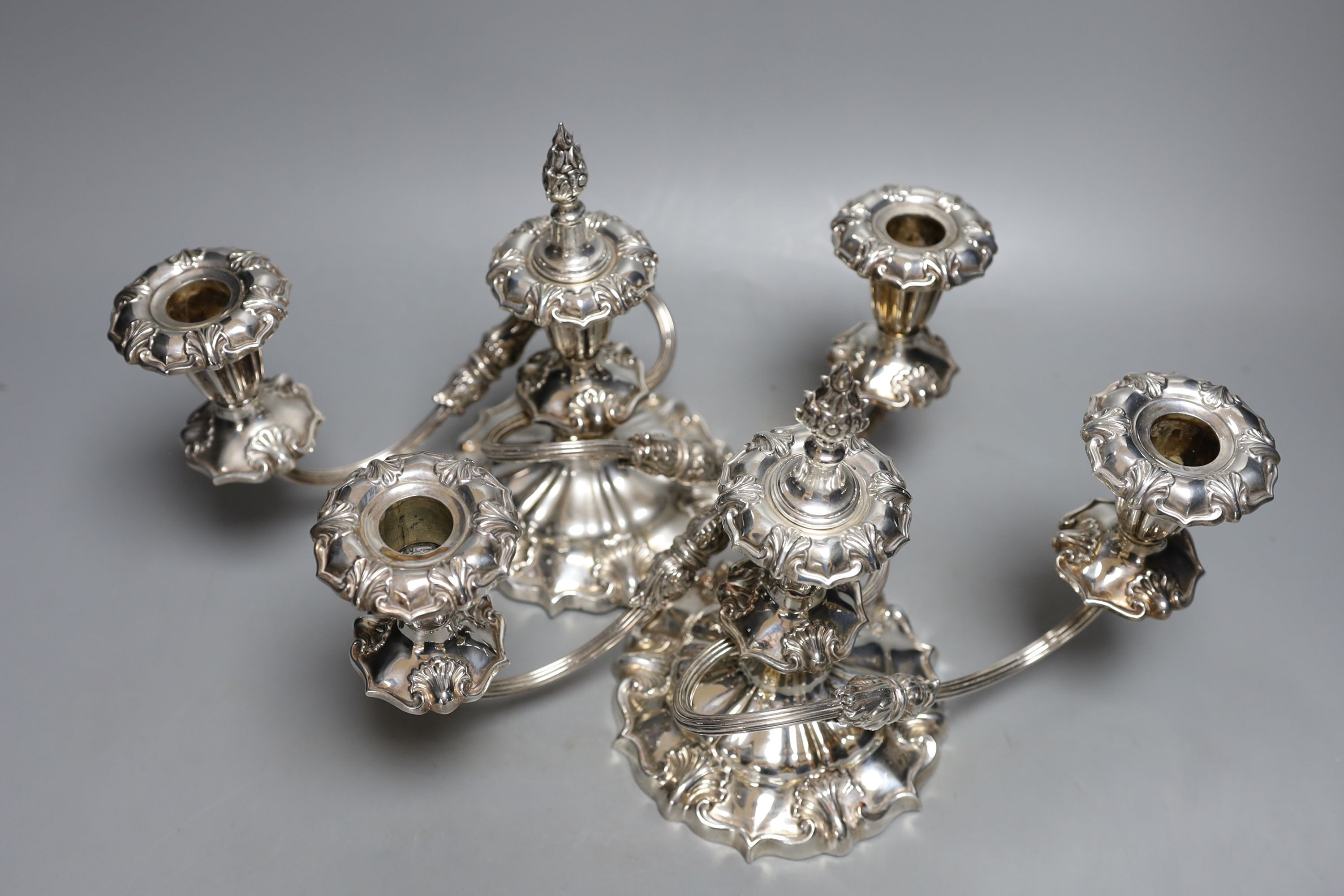 A pair of plated three-light candelabra, 33cms wide.